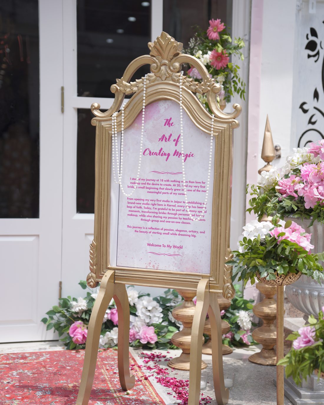 Welcome sign at the studio entrance, surrounded by flowers