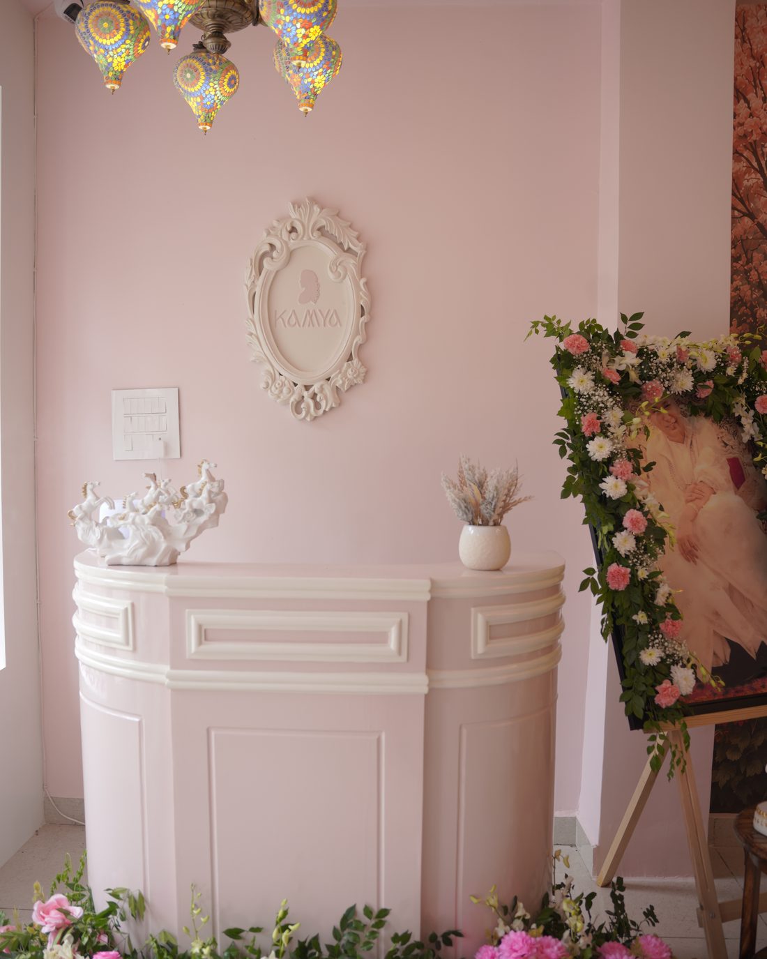 Reception desk framed by flowers at the studio entrance