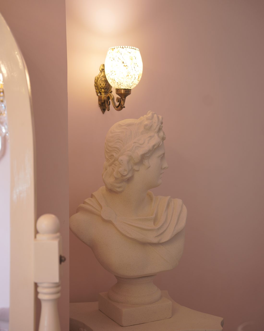 Classical bust and wall sconce, a corner detail inside the studio